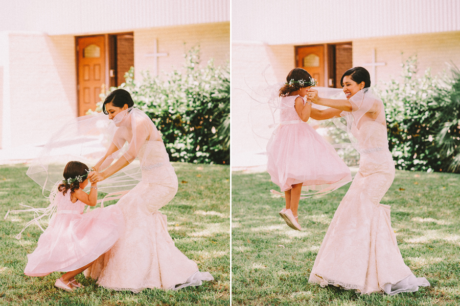 bride playing with flower girl